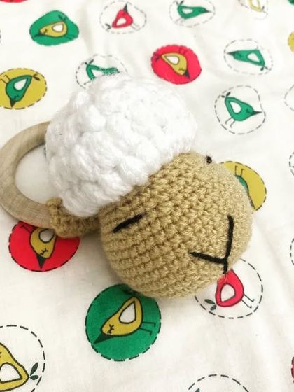 Baa Baa Black Sheep, have you any rattle? This adorable sheep rattle with a natural wood ring is safe for teething and provides a gentle sound for sensory play.