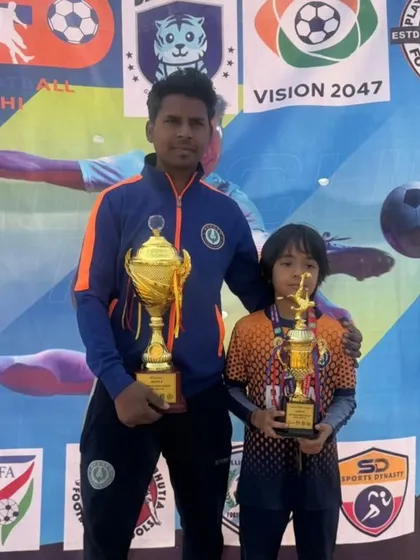 A proud moment for both player and coach. Arash and his mentor celebrate their shared success and hard work.