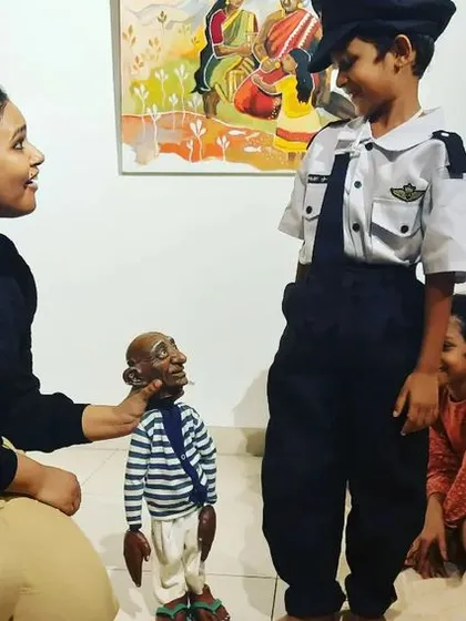 A moment of gentle interaction between our puppet and a child at our art gallery workshop.
