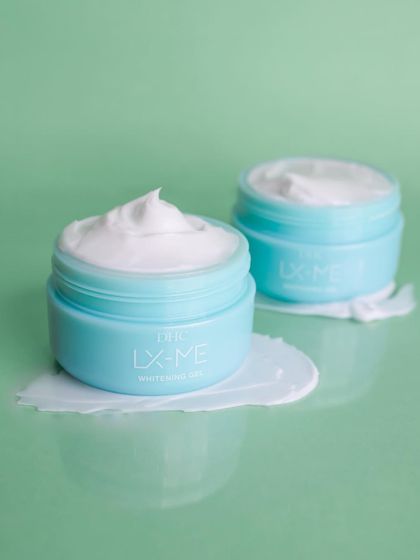 This shot for DHC Beauty showcases the product's texture with a satisfying smear on a reflective surface, giving a sense of its smooth and hydrating properties.