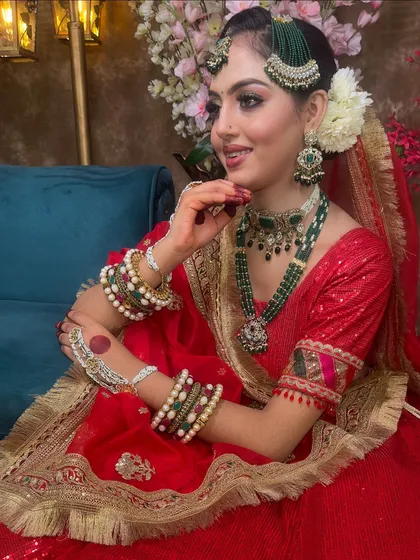 This red sequin lehenga is styled here for a Muslim bridal look, featuring a passa and green jewellery. It shows how versatile a classic red lehenga can be.