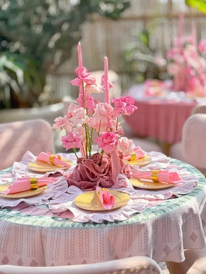 A different table setup from the same event, using a patterned tablecloth but maintaining the blush pink theme.
