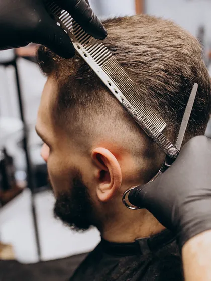The foundation of a great men's haircut lies in technique. This is a glimpse of our scissor-over-comb method, a fundamental skill our barbers use to create seamless fades and structured styles.