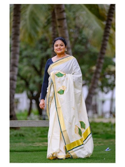 Another shot from the same series, showing the saree's leaf-motif details and the traditional way it is worn.