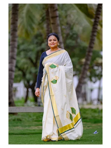 Another shot from the same series, showing the saree's leaf-motif details and the traditional way it is worn.