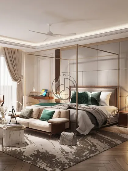 This master bedroom at DLF Camellias is an expression of restful luxury. It features a four-poster bed with a gold frame, layered textures, and a comfortable lounge area with a view.