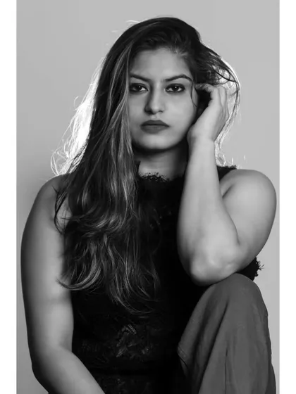 An intense and emotional monochrome portrait. The model's pose and expression are the central focus, creating a powerful and captivating image.