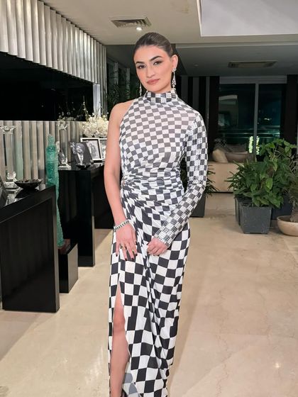 A full-length shot of this modern and edgy look. The makeup is minimal to let the architectural dress be the star.