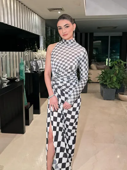 A full-length shot of this modern and edgy look. The makeup is minimal to let the architectural dress be the star.