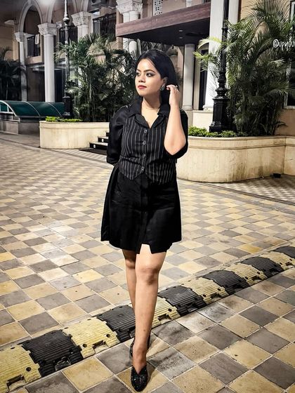 This pinstripe shirt dress is a modern take on classic corporate wear. It's a one-piece solution for looking put-together and professional with minimal effort.
