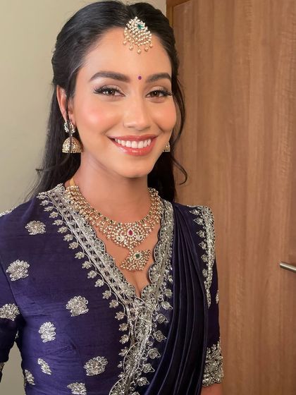 A close-up showing her beautiful smile and the soft, radiant makeup that makes her skin look lit from within.