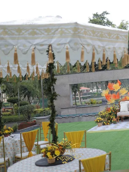 A view of the Haldi setup, showing the guest seating and the couple's stage in the background, all unified by the yellow and orange color scheme.