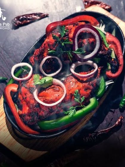 A sizzling platter of our famous Tandoori Chicken, garnished with fresh peppers and onions. The steam shows you just how fresh and hot it is.