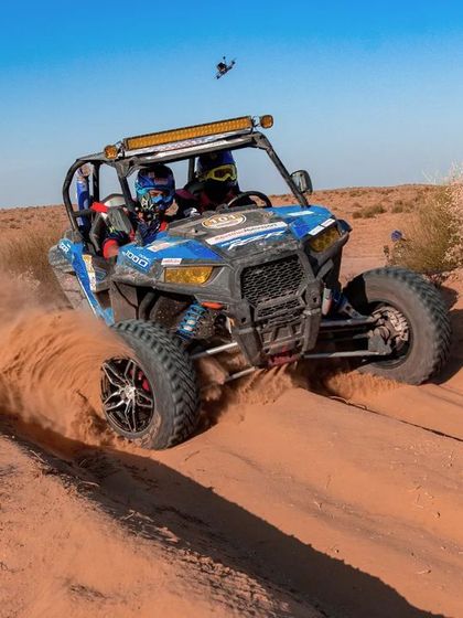 Behind the scenes at a desert race, with my drone perfectly positioned above a Polaris ATV as it navigates a sandy turn.