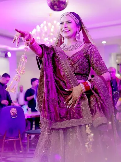 The bride's solo dance performance, capturing her energy and the vibrant lighting of the event.