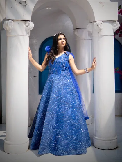 This look for a designer gown shoot shows how makeup completes the entire vision. I created a soft glam look with a smokey blue-toned eye to match the royal blue dress, ensuring the model looked elegant and the makeup photographed beautifully in natural outdoor light.