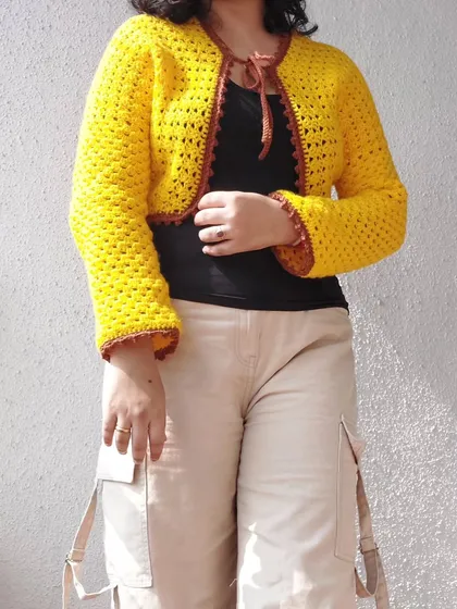The Odette Cardigan is a versatile layering piece, perfect for adding a pop of color to any outfit.