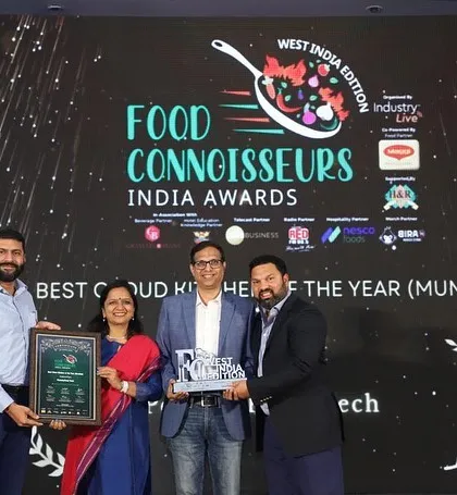 I am proud to be on stage receiving the Food Connoisseurs India Award for 'Best Cloud Kitchen of the Year' in Mumbai. This recognition reflects my commitment to quality and excellence.