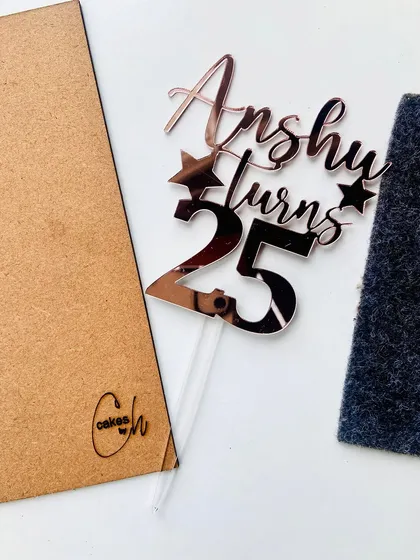 Celebrate a silver jubilee in style. This "Anshu turns 25" topper in a reflective rose gold finish adds a touch of sophistication, perfect for marking a quarter-century milestone.