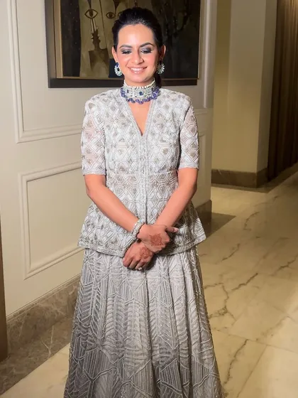 Glowing and glamming in a beautiful Ritika Mirchandani outfit. The makeup is clean and sophisticated, with a defined eye and a sleek updo to complete the look.
