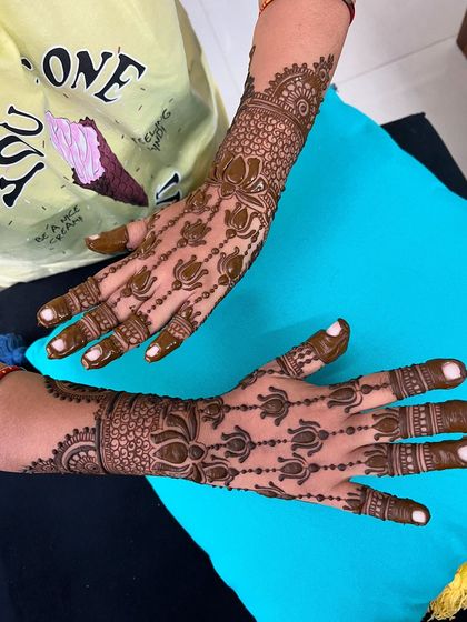 A view of both hands, showing the elegant and flowing nature of the design.