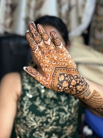 The back of the hand, featuring a lovely floral and paisley pattern.