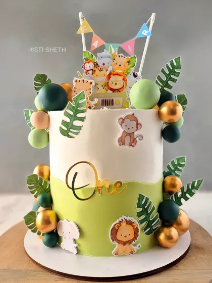 A classic jungle-themed cake with cute animal toppers, monstera leaves, and a two-tone green and white design. This is my popular Chocolate Mousse flavour.