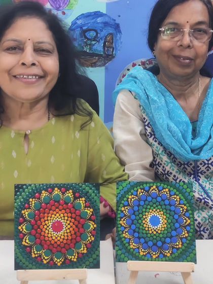 Two friends enjoying a dot painting session together at the ArtBox Studio. They each created a unique and colourful mandala on a small canvas, showcasing their individual styles while sharing a creative experience.