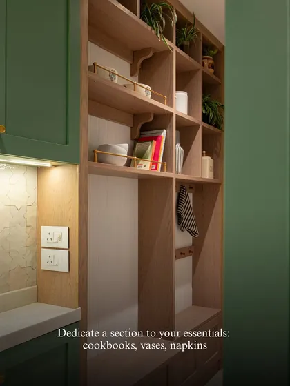 Dedicate a section of your open shelving to essentials like cookbooks, vases, and napkins. This not only keeps them organized but also turns them into a beautiful, curated display.