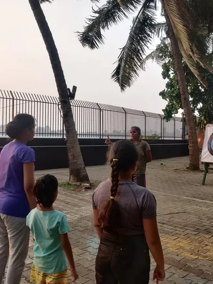 An instructor explains the day's lesson to a group of eager students.