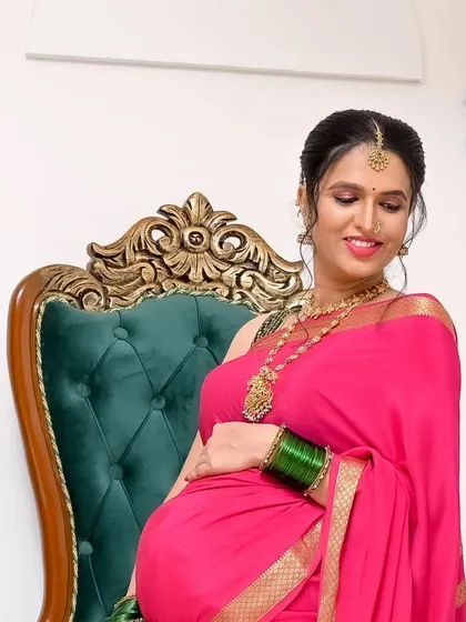 Maternity shoots can also be traditional. I styled this client for her baby shower ceremony, creating a classic look with a bright pink saree, traditional gold jewelry, and elegant makeup to celebrate this special time.