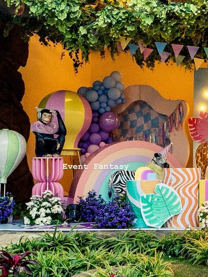 Another view of the "Party Animal" theme, with a monkey prop, a rainbow, and colorful hot air balloons creating a playful and festive scene.