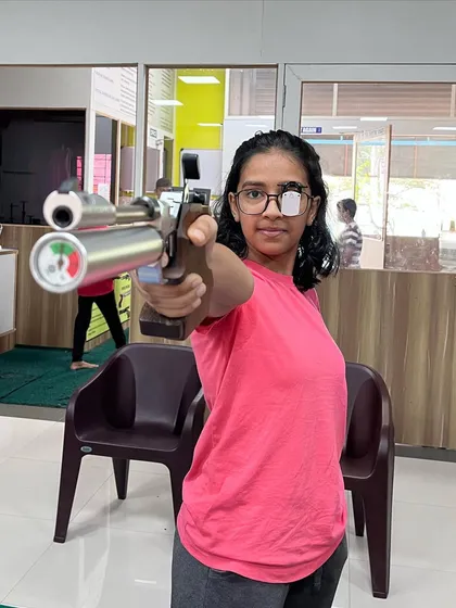 A young shooter holds her stance, demonstrating the focus and discipline that the sport instills. This is a preview of the professional air pistol training we provide as our students prepare for state-level competitions.