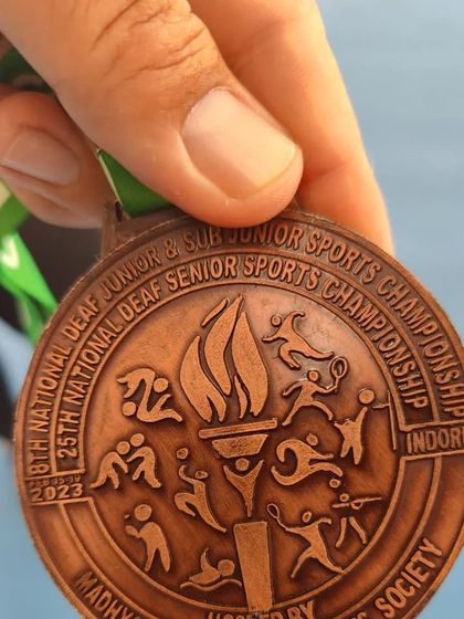 A close-up of the bronze medal won at the National Deaf Sports Championship. Every medal is a symbol of the perseverance and spirit of our athletes.
