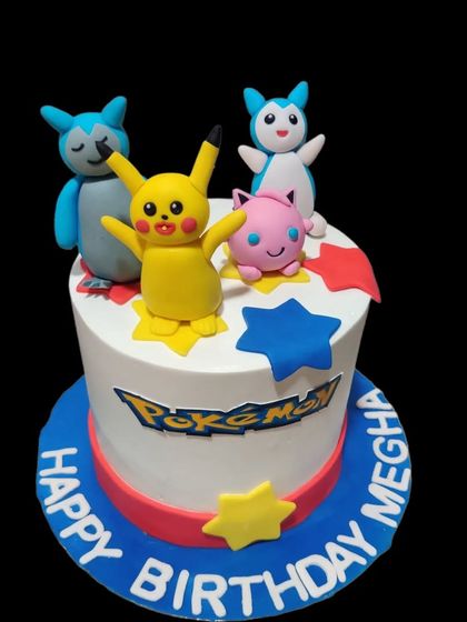 Gotta catch 'em all with this Pokémon-themed cake. It features adorable, handcrafted figures of Pikachu, Jigglypuff, and other Pokémon, ready for a birthday adventure.