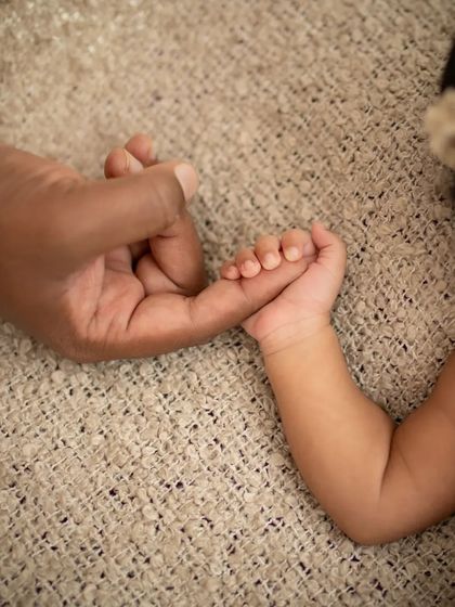 So tiny, so loved. This close-up of a newborn's tiny feet held in their parent's hand shows just how small and precious they are. A detail you'll never want to forget.
