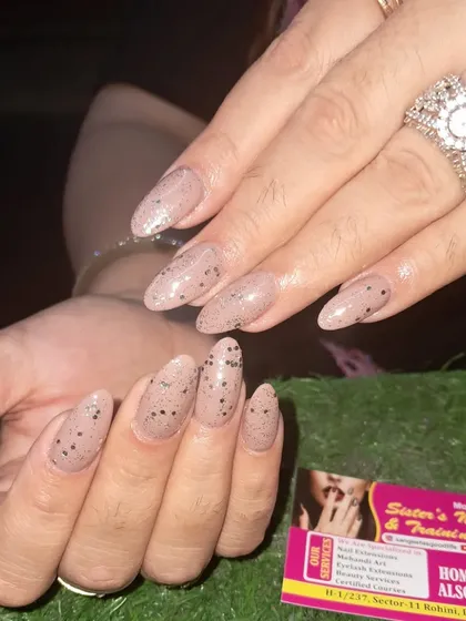 A unique and stylish design with a speckled nude polish that looks like a quail egg, perfect for a subtle but interesting look.