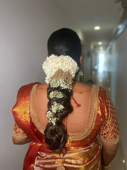 A close-up of the intricate braiding and the beautiful arrangement of fresh flowers.