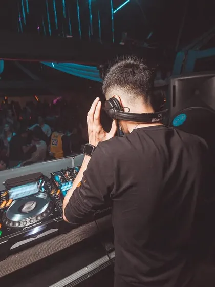 A view from behind me, showing my perspective as I look out onto the crowd while cueing up the next track in my headphones.