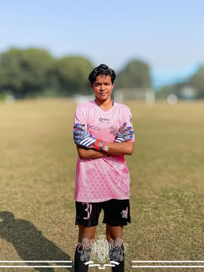 The last line of defense. Our goalkeeper stands ready, a picture of confidence and control.