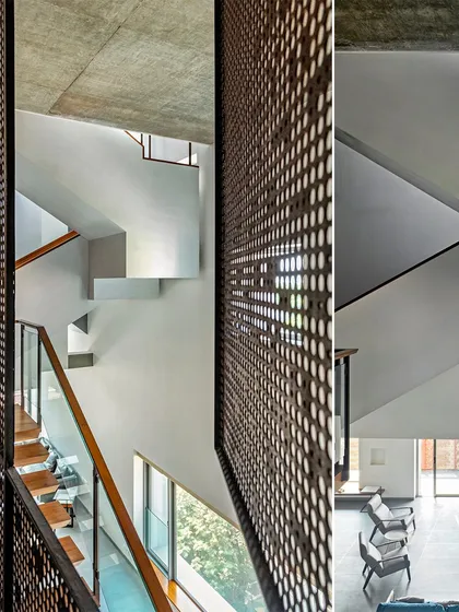 The multi-story interior of J-House is connected by a network of voids and staircases, with perforated screens allowing light and air to flow vertically through the home.