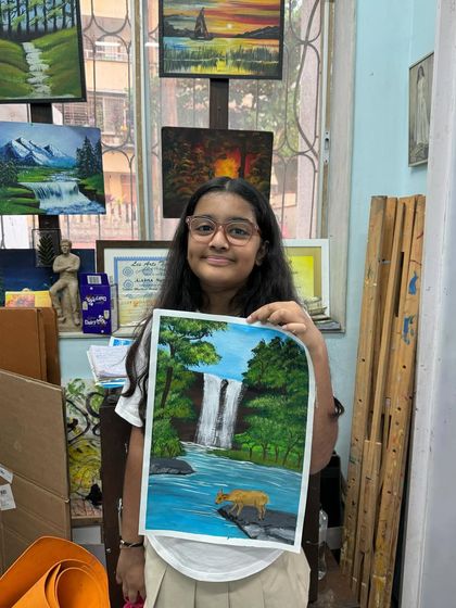 A lush waterfall scene painted with great attention to detail. Notice the little tiger perched on the rock, a wonderful storytelling element added by the artist.