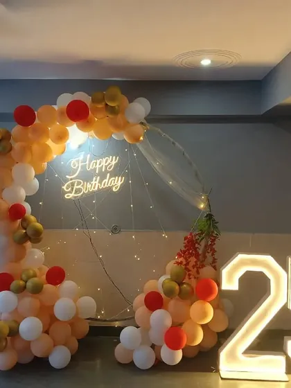 A duplicate of the peach, white, and red semi-circular balloon arch setup for a 25th birthday.