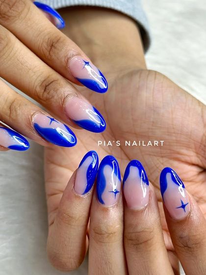 Dreamy blue nails with a transparent base, creating a cool "jelly" effect with tiny star details.