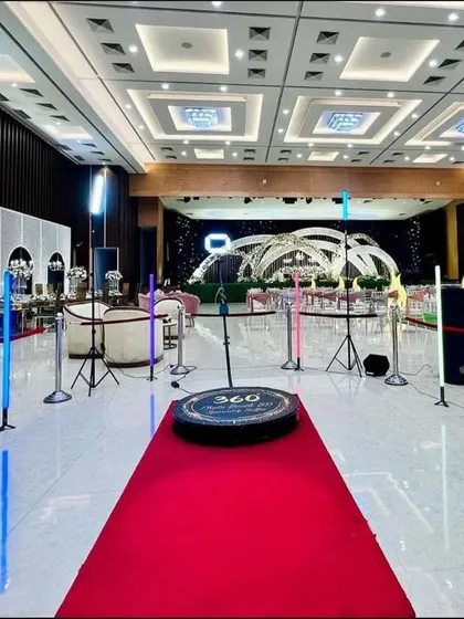 Here is my complete VIP setup in a grand wedding hall. I provide the red carpet, professional lighting, and safety stanchions to create a dedicated, high-energy zone that becomes the center of attention at any event.