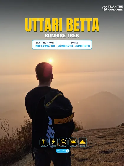 A trekker looks out at the sunrise from Uttari Betta.