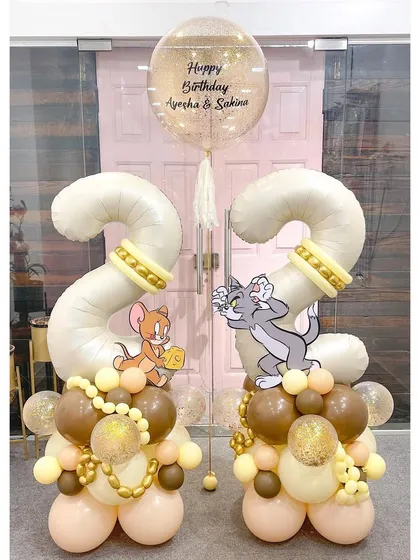 A playful Tom and Jerry theme for a 22nd birthday. This symmetrical setup features the iconic duo on matching number '2' displays, all in a neutral and stylish color palette that's perfect for an adult fan.