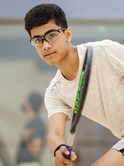 A close-up portrait of 15-year-old Abdus Samad, another rising star on the Goan squash team. The sharp focus and determined look highlight the intensity he brings to the court.