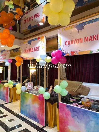 A full view of our art carnival setup. By creating different booths for each craft, we can handle large groups and make sure everyone has a chance to try everything.