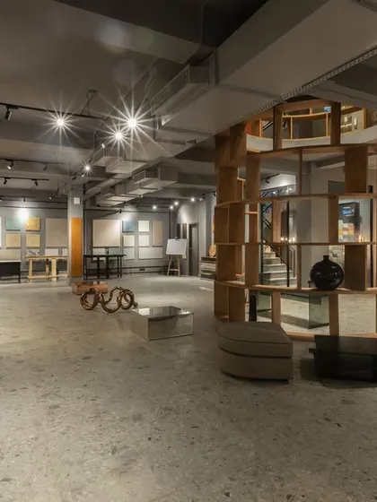 Another view of the SIRCA HQ showroom, highlighting the custom wooden shelving unit that acts as a central sculptural element. The space is open, modern, and designed for exploration.